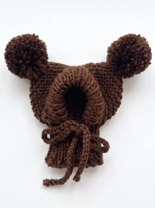 Dark brown knitted dog hood with two pom-poms